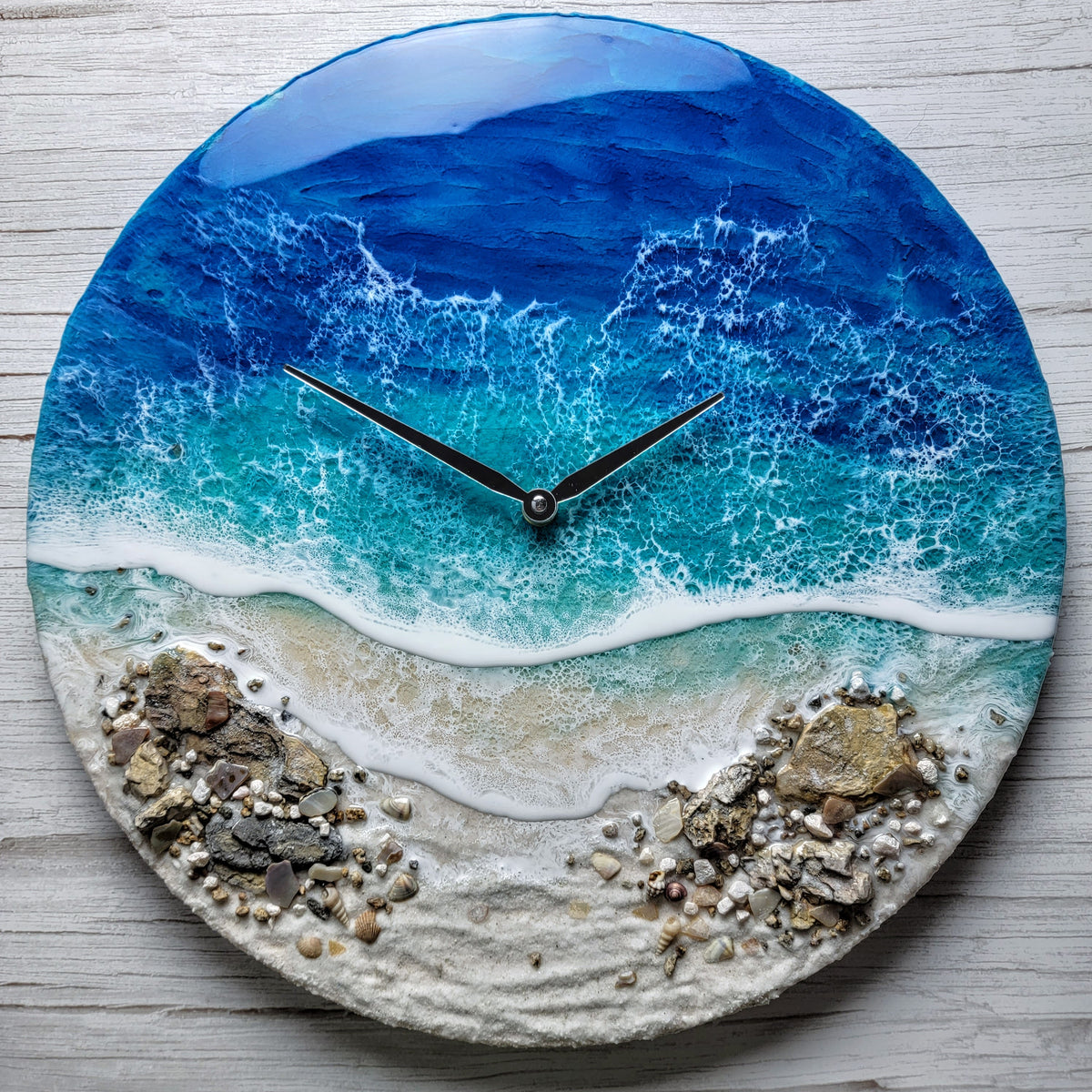 handmade clock with epoxy waves, rocks, seashells and sand.